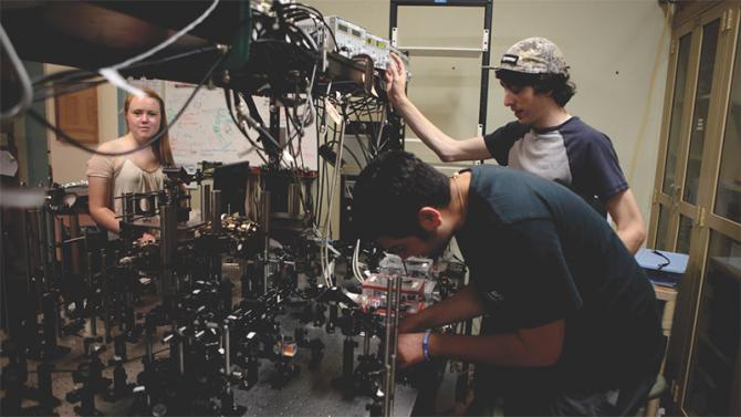 Physics students using a magneto-optical atom trap