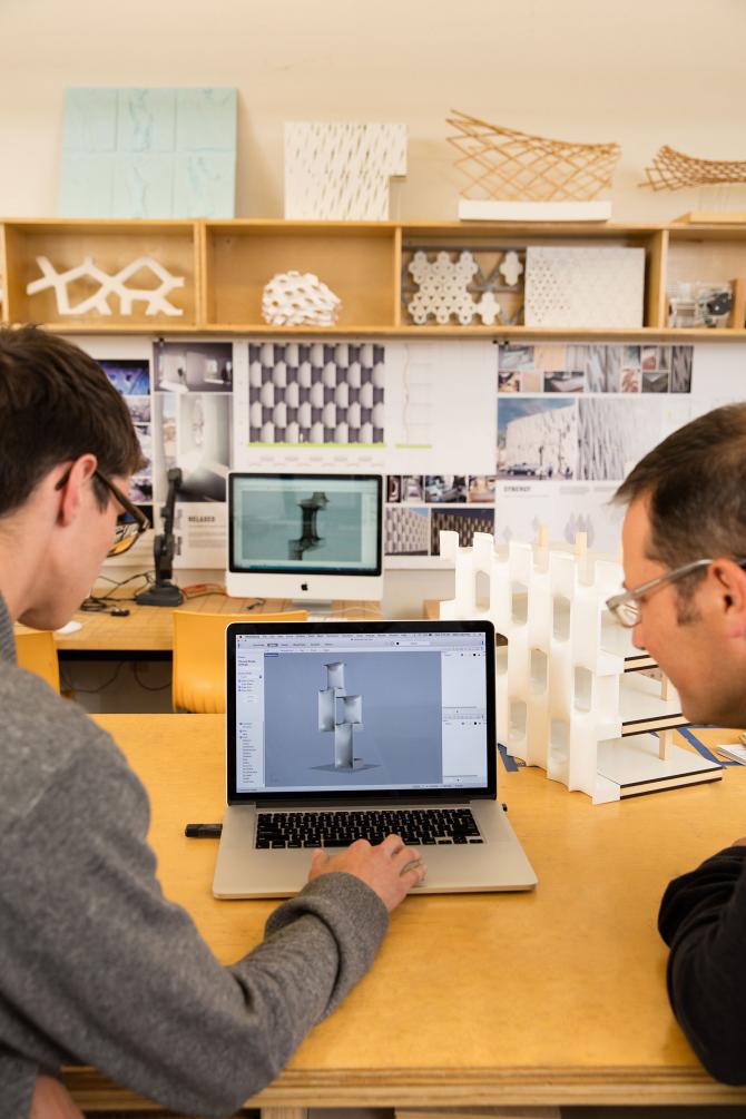 Two CAED students in the Digital Fabrication lab