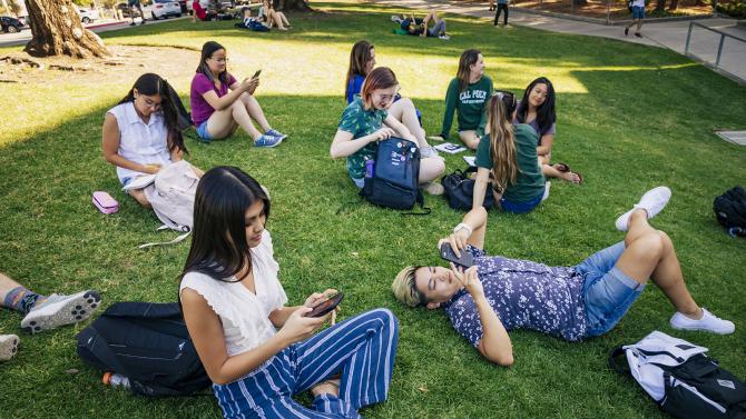 Group of students on the lawn in front of the library.