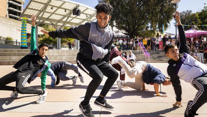 Student breakdancers performing in the UU Plaza