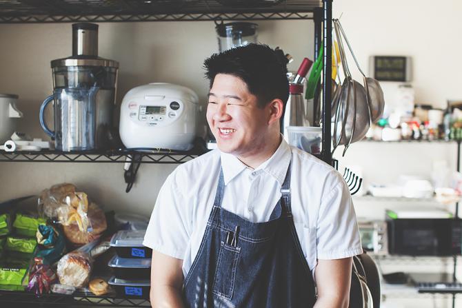 Jimmy Wong in a kitchen, wearing an apron