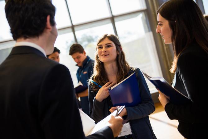 Students talk with employers at a career fair