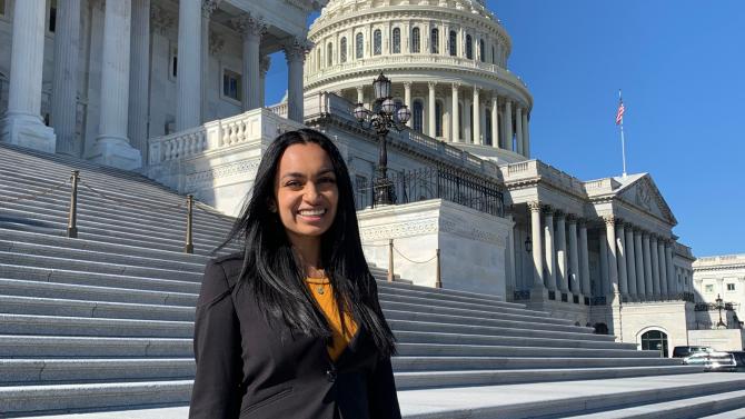 Desiree Nunes wears a black blazer while standing on the steps of the United States Capitol