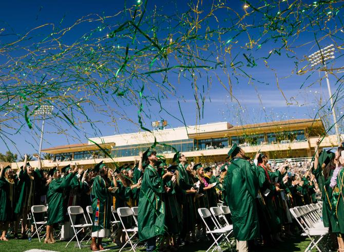 Confetti rains down over graduates at commencement. 