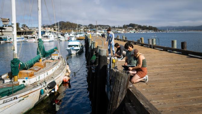 Students work on wave and tidal sensors at the Coast Guard Pier in Morro Bay