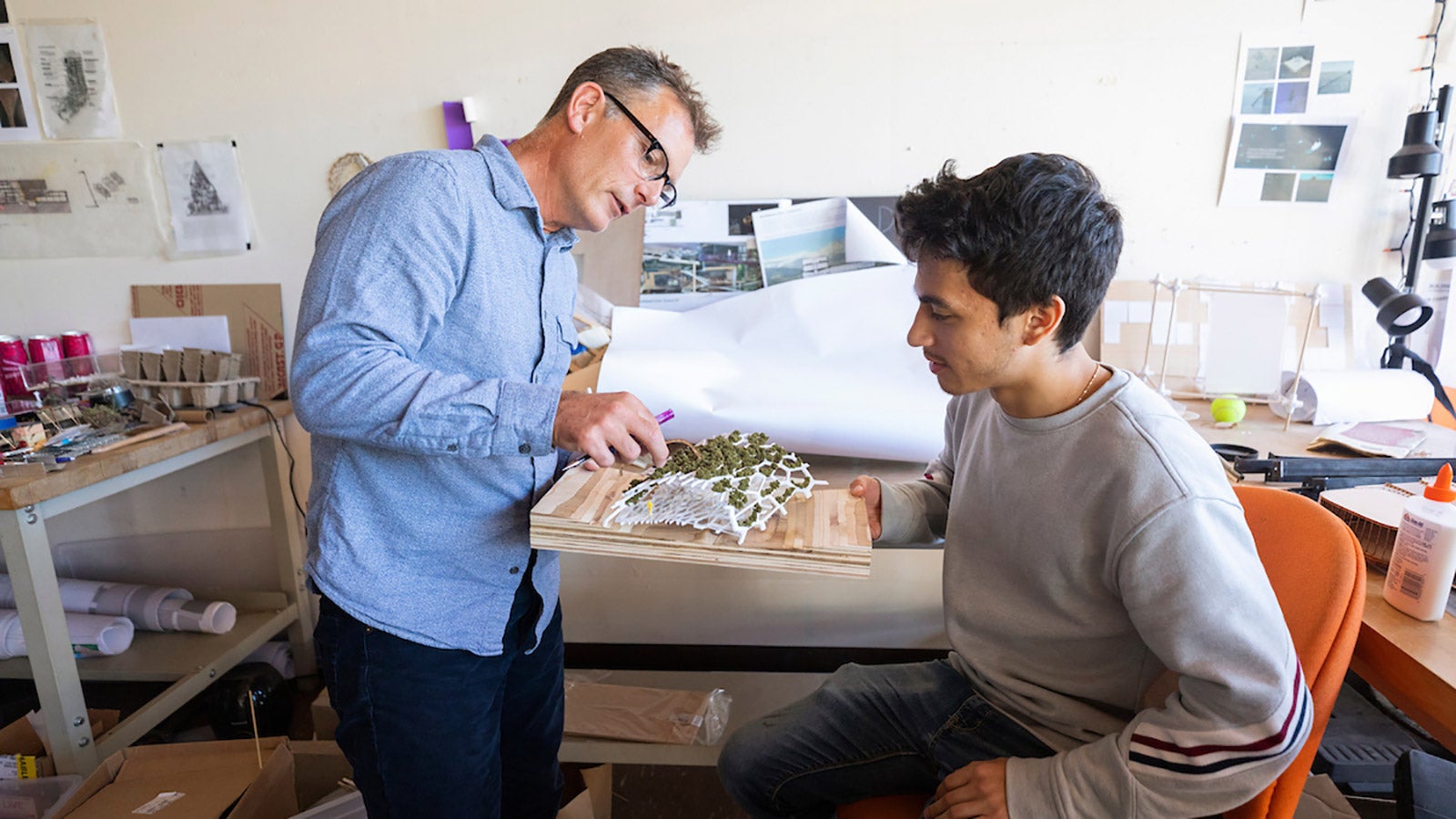 Architecture professor and student working together on model