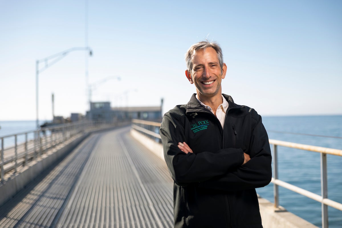 Ben Ruttenberg smiles for a photo on the Cal Poly Pier.