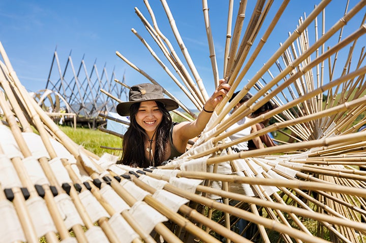 A student from Cal Poly’s College of Architecture & Environmental Design work on their structure for the Design Village competition. 