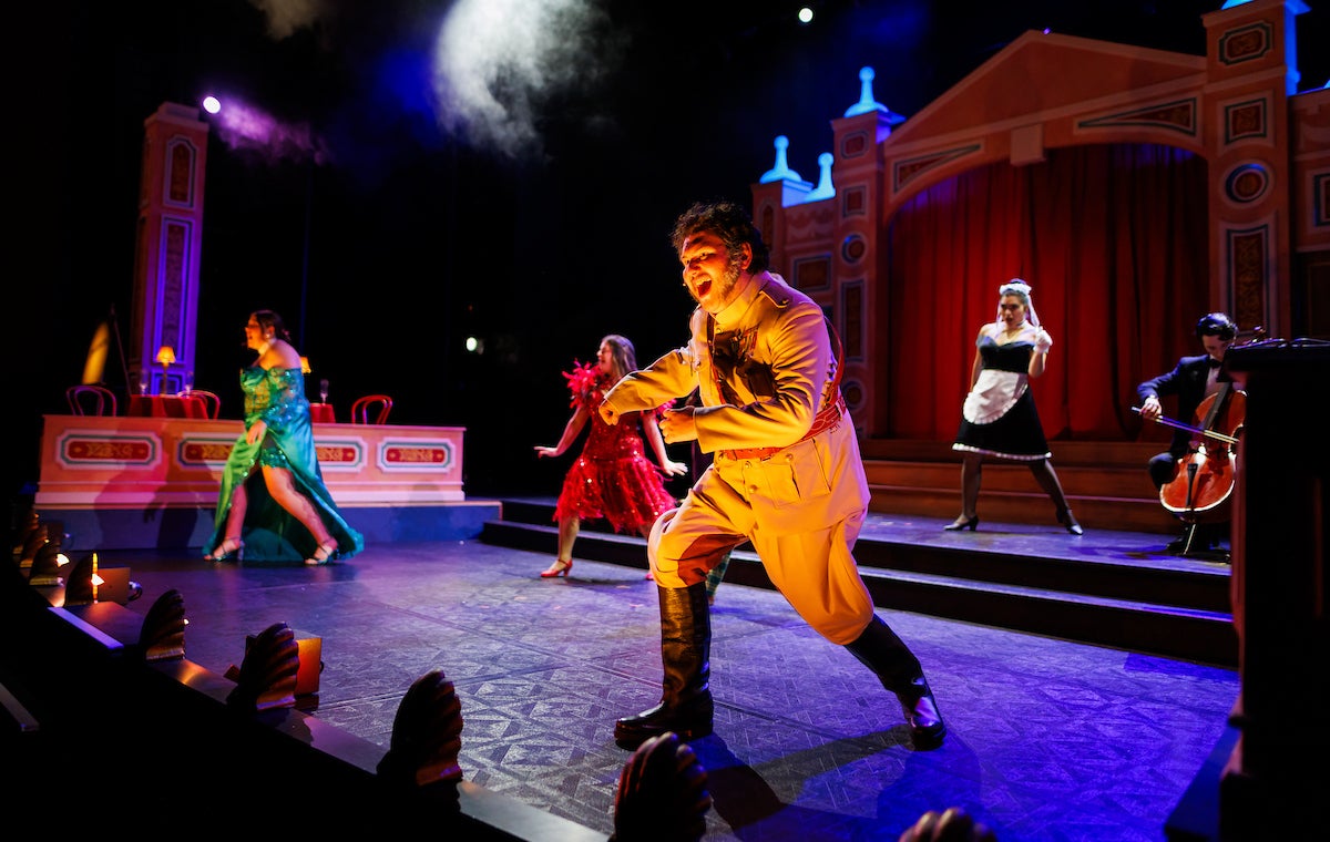 Students in costumes from the board game Clue dance onstage.