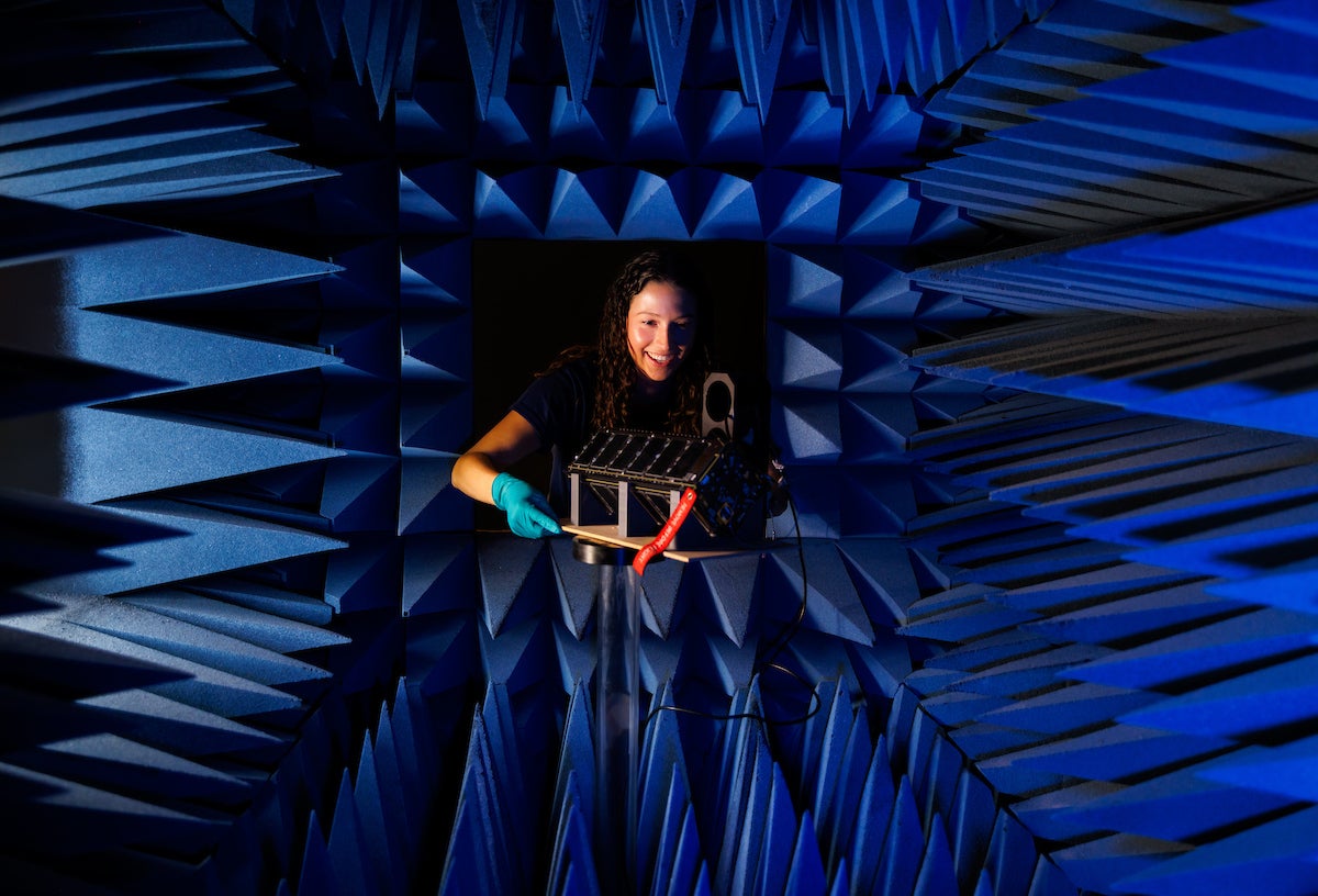 A student in a textured space tests a mechanical component.