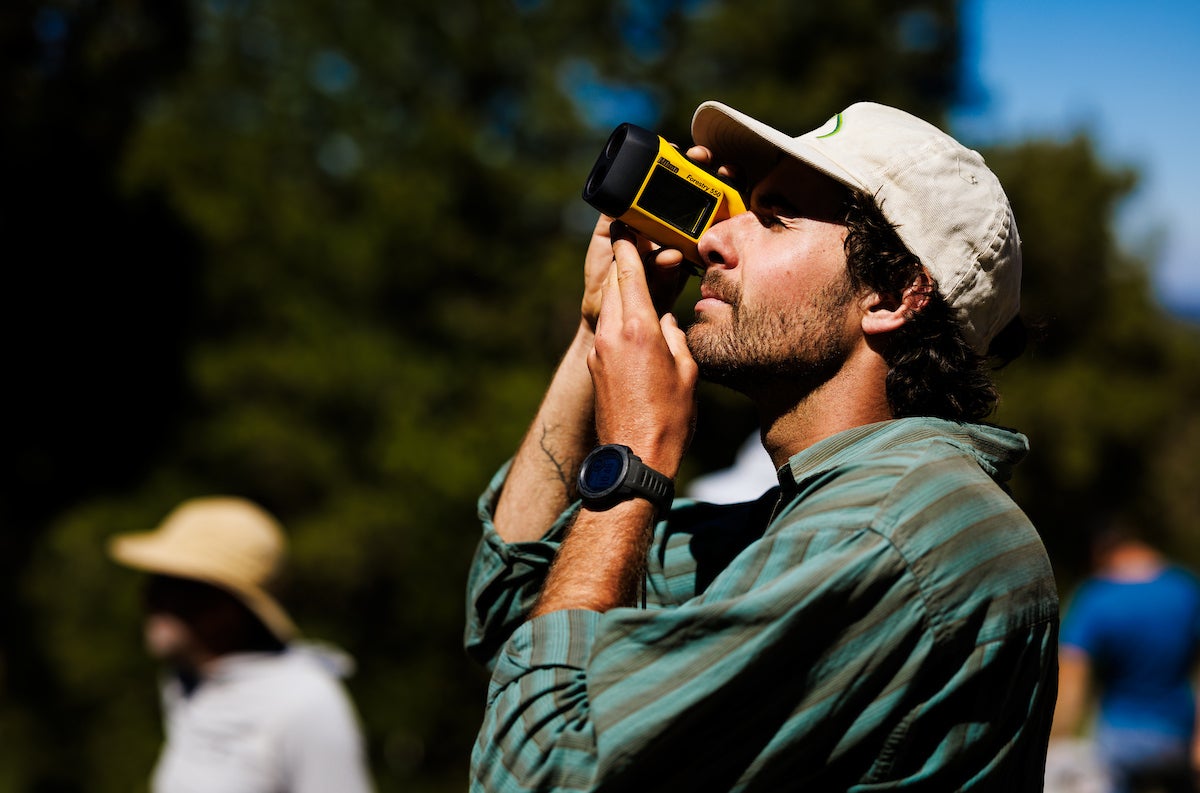 A student uses a laser rangefinder.