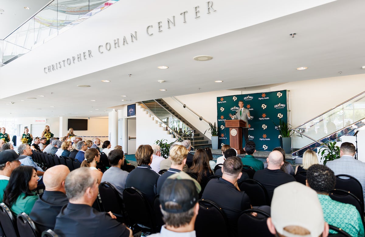 Carter Henderson speaks to a crowd in the Performing Arts Center Lobby.