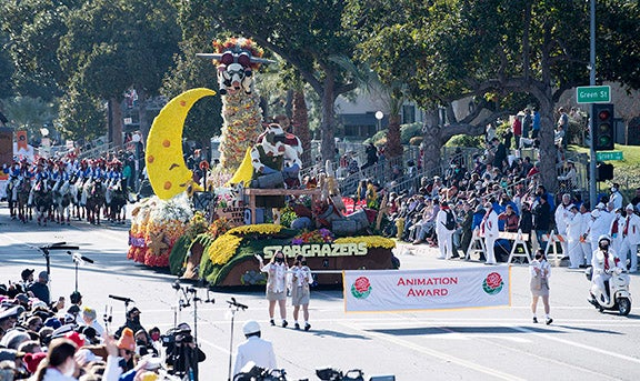Cal Poly universities' Stargrazers float appears in the Rose Parade, led by the banner annoucing the Animation Award
