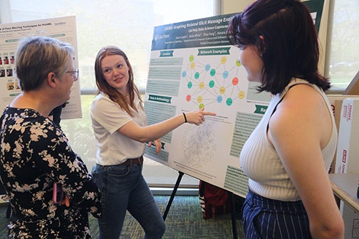 Cal Poly students show Dean Fleischer their capstone social network graph