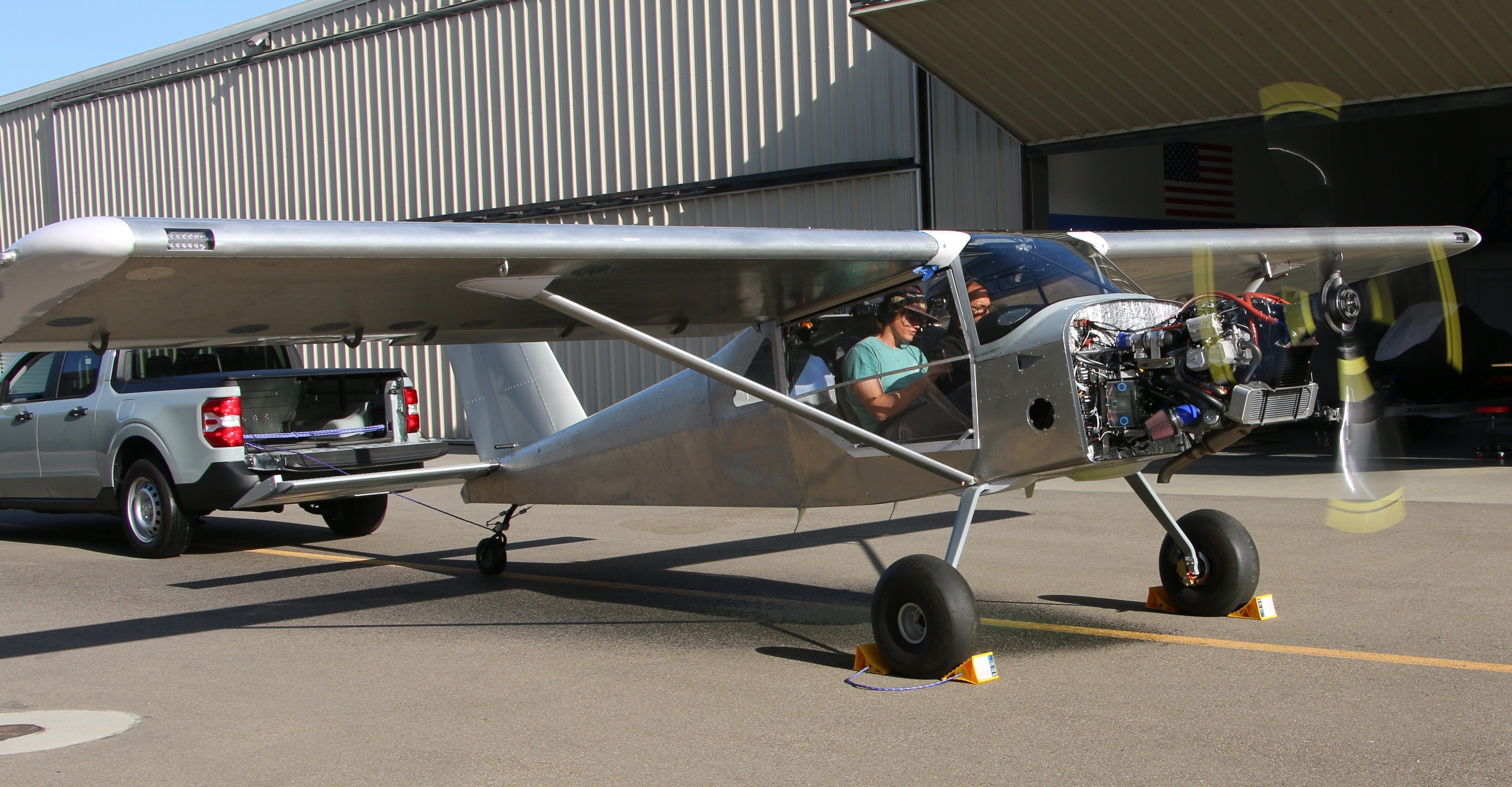 A student and professor sit in an airplane together.