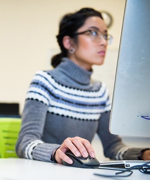 A student works on a computer.
