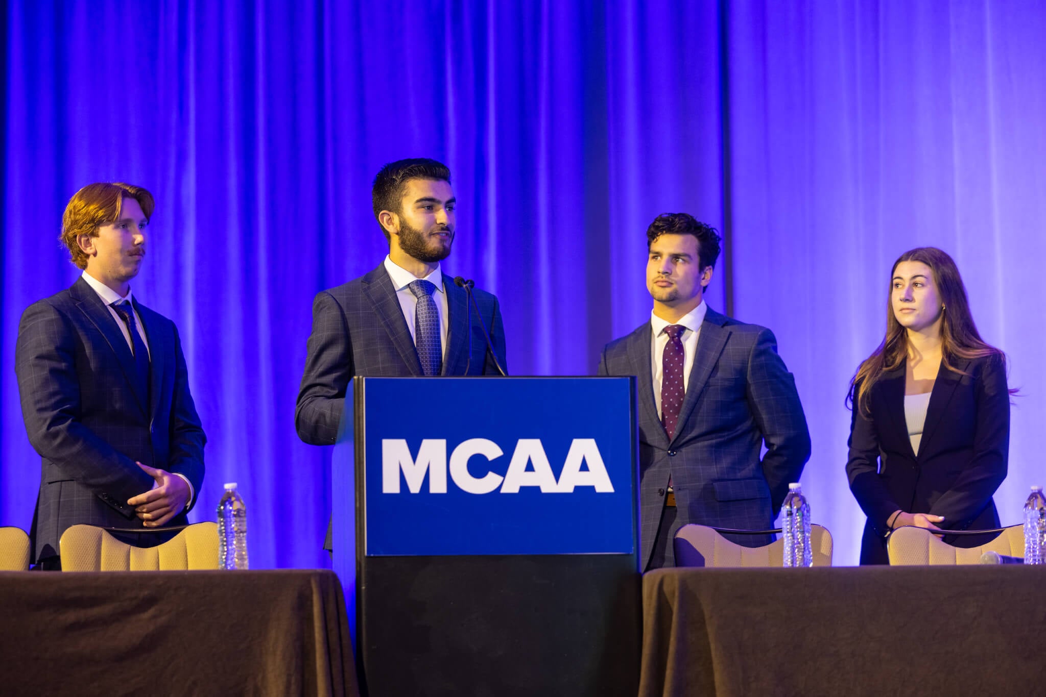 Misael Gonzalez Ramirez speaks at a podium during a competition.