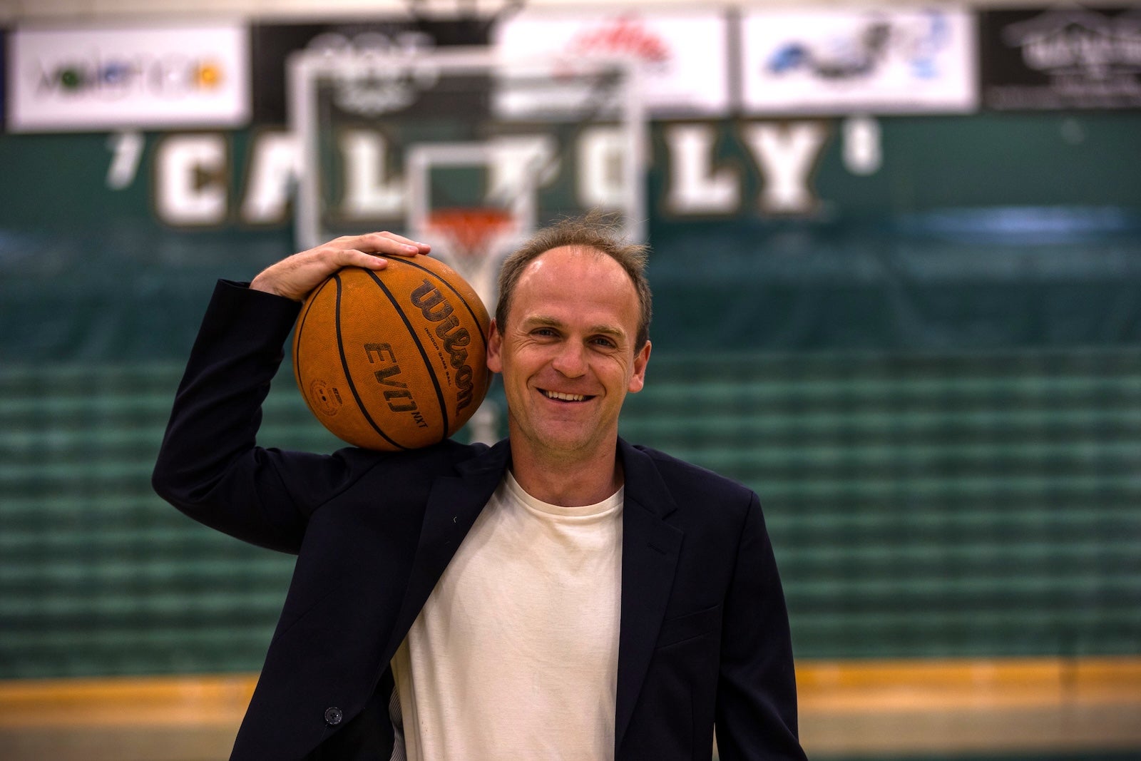 Joseph Kuehn poses with a basketball in Mott Gym.