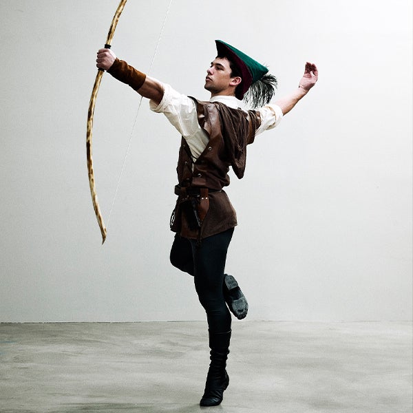 A performer posing as Robin Hood for a ballet performance.