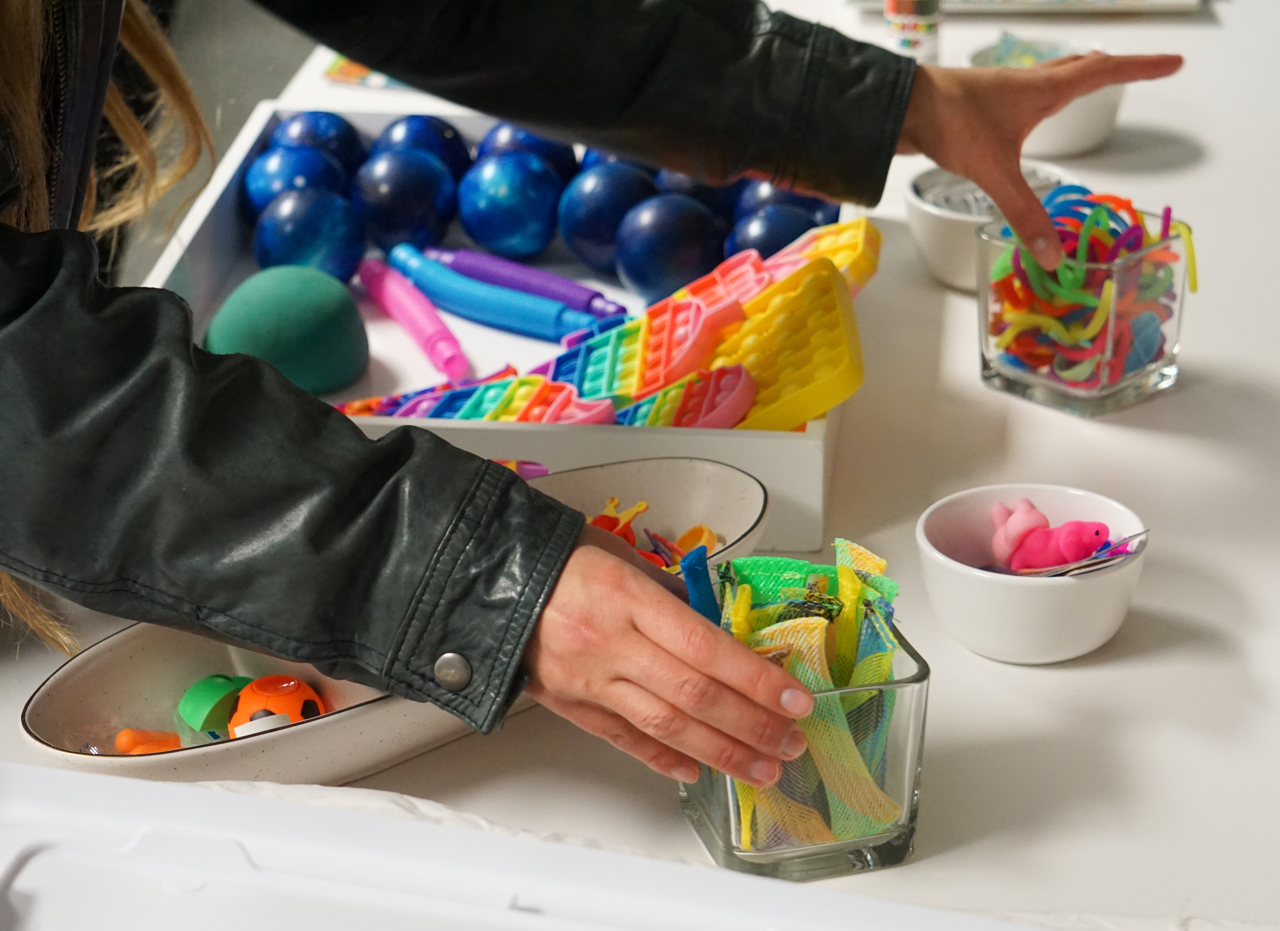 A student sets out boxes of knickknacks in the resilience room.