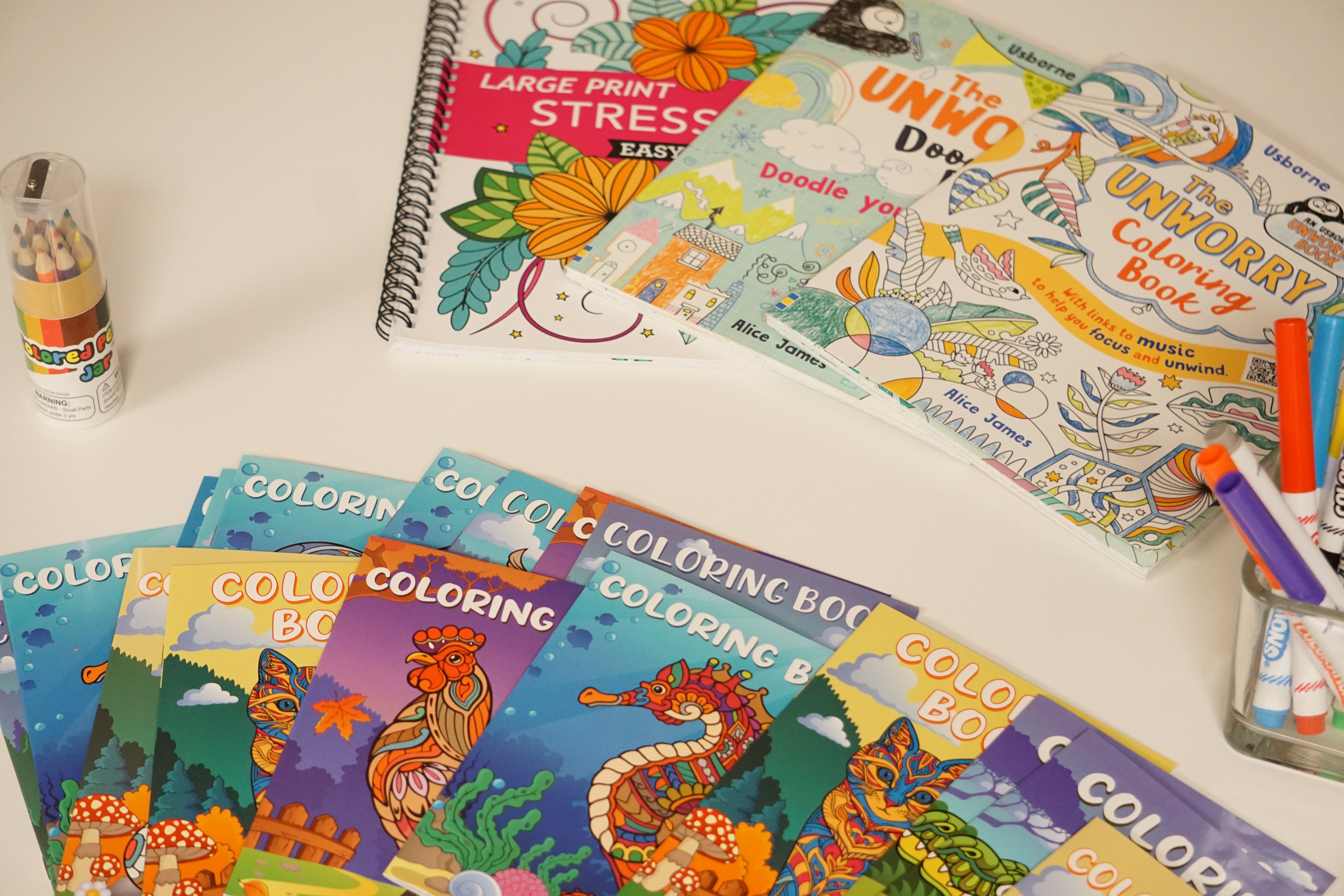 Coloring books and pencils on a table.