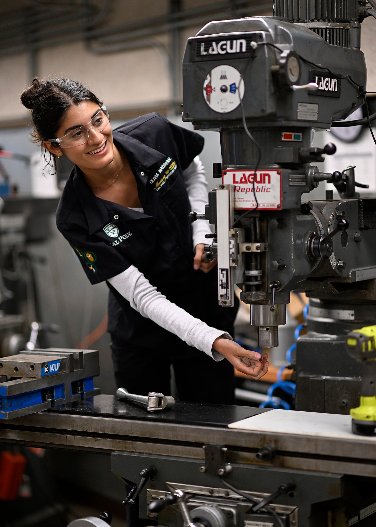 Olivia Madrigal, wearing protective gear, works with machines.