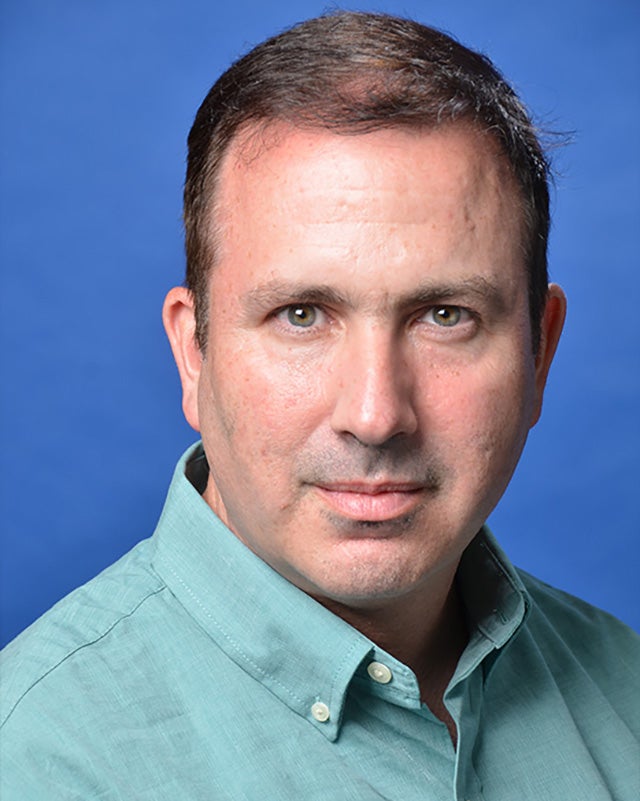 A headshot of Joshua Shackman.