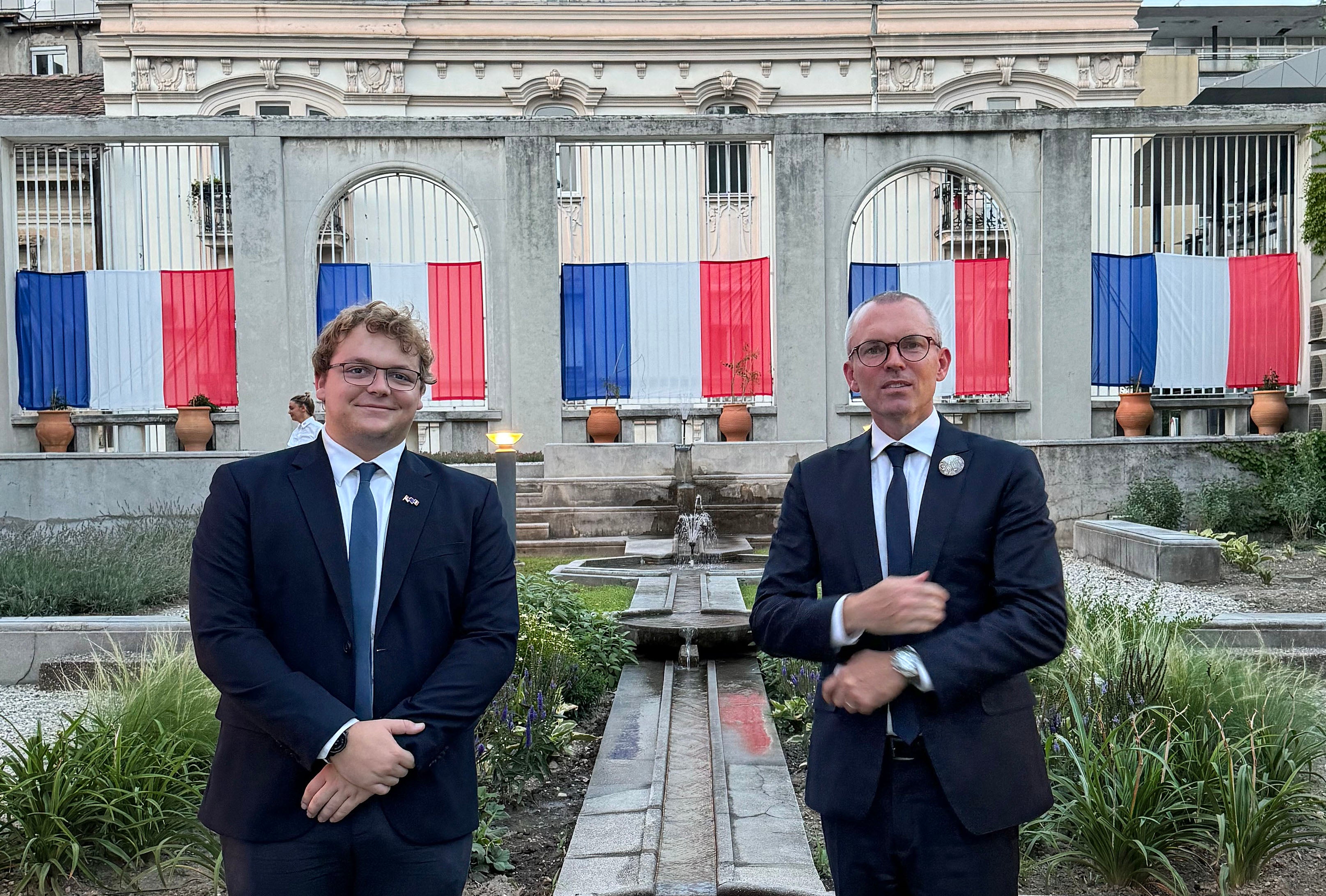 Nico Julia, left, with an older man, both wearing suits.