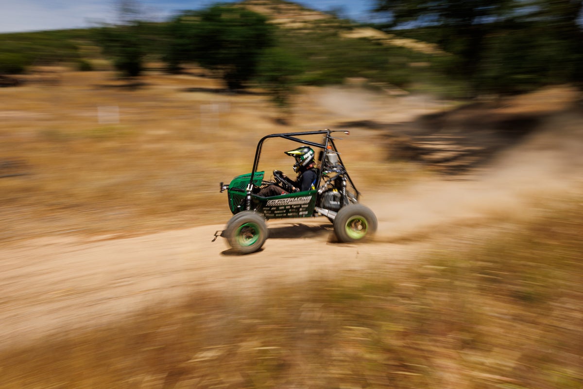 Cal Poly Racing's off road baja car speeds down a dirt trail