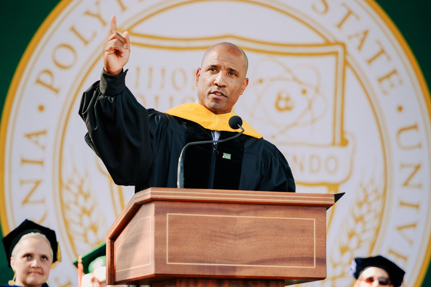 Victor Glover at the podium giving a speech during commencement.