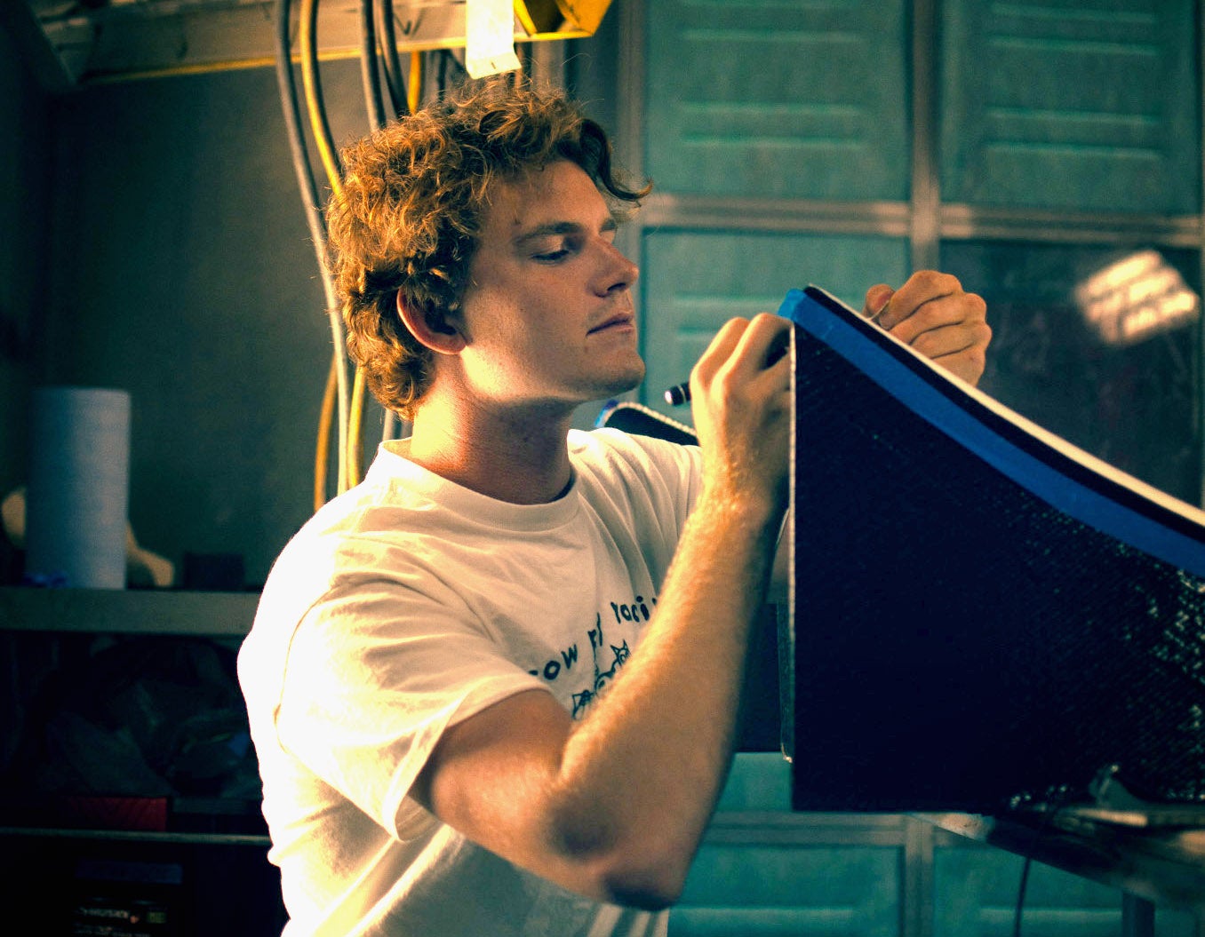 John O'Donnell works on a piece of a race car.