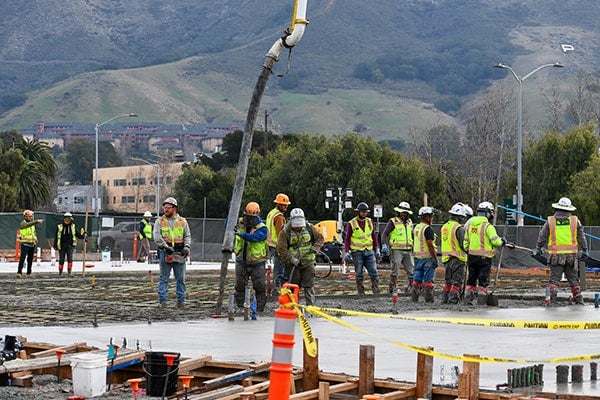 A group of construction workers work on a project at Cal Poly. 