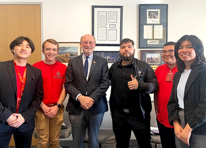 A group of students poses with Senator John Laird.