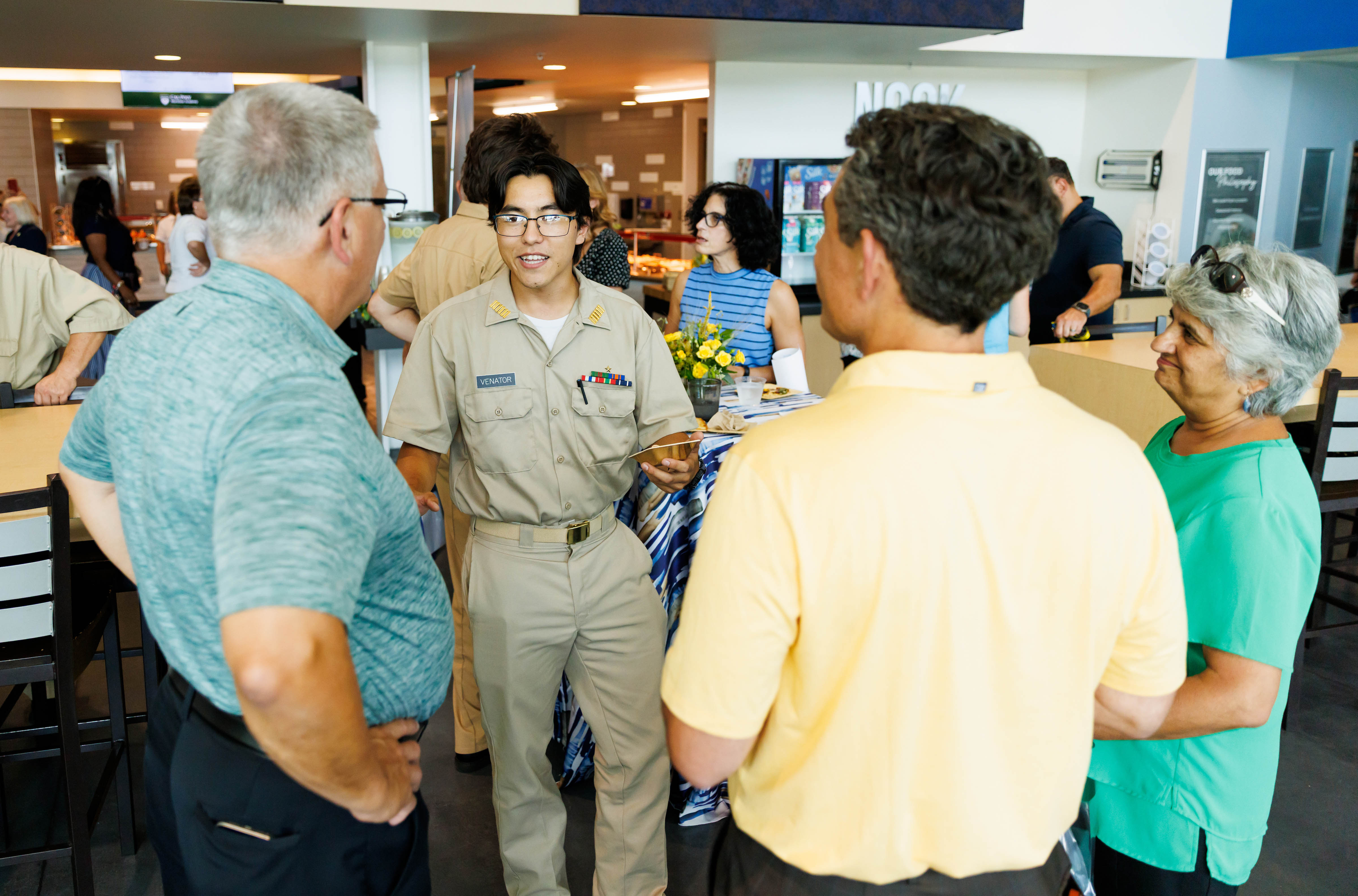 Tyler Venator speaks to visitors while in uniform.