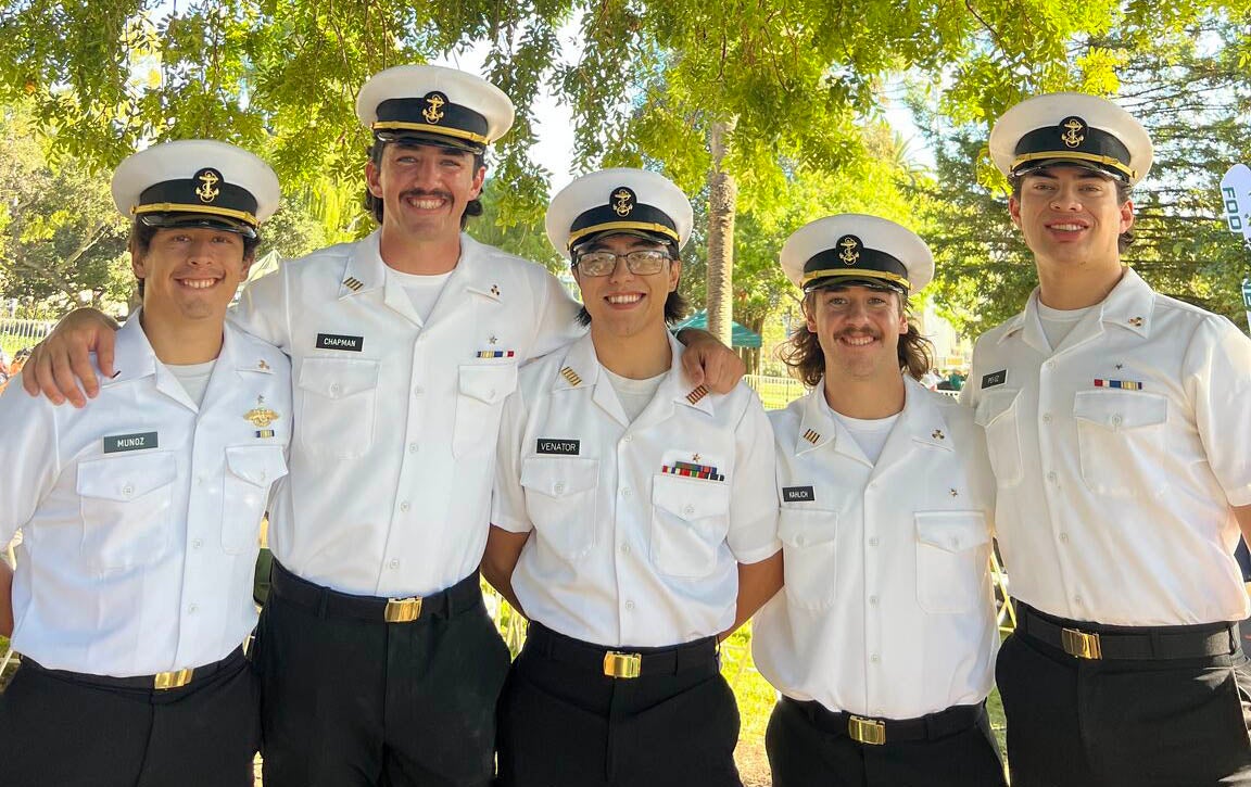 Tyler Venator with other cadets in white and black uniform.
