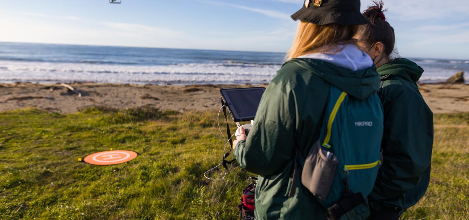 Graduate students Kate Riordan and Molly Murphy operate the drone at one of the beaches in the Piedras Blancas rookery. NMFS permit #22187-02
