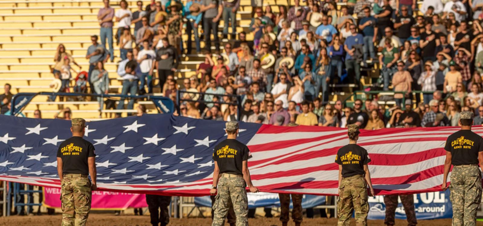 Cal Poly Army ROTC students hold the American flag at the 2019 Poly Royal Rodeo.