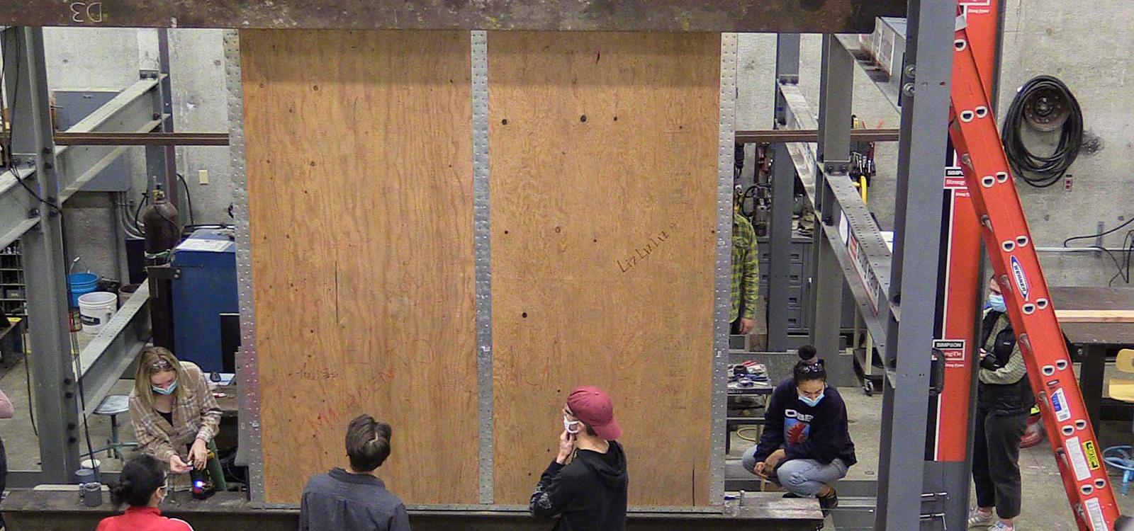 Cal Poly ARCE Students prepare for a shear wall test. 