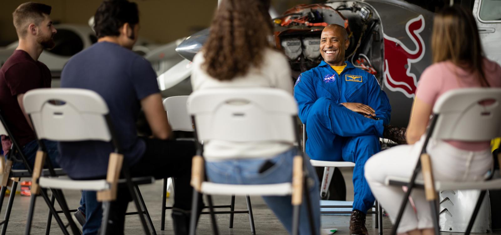 Captain Glover talks to students working on experimental planes at the San Luis Obispo Regional Airport