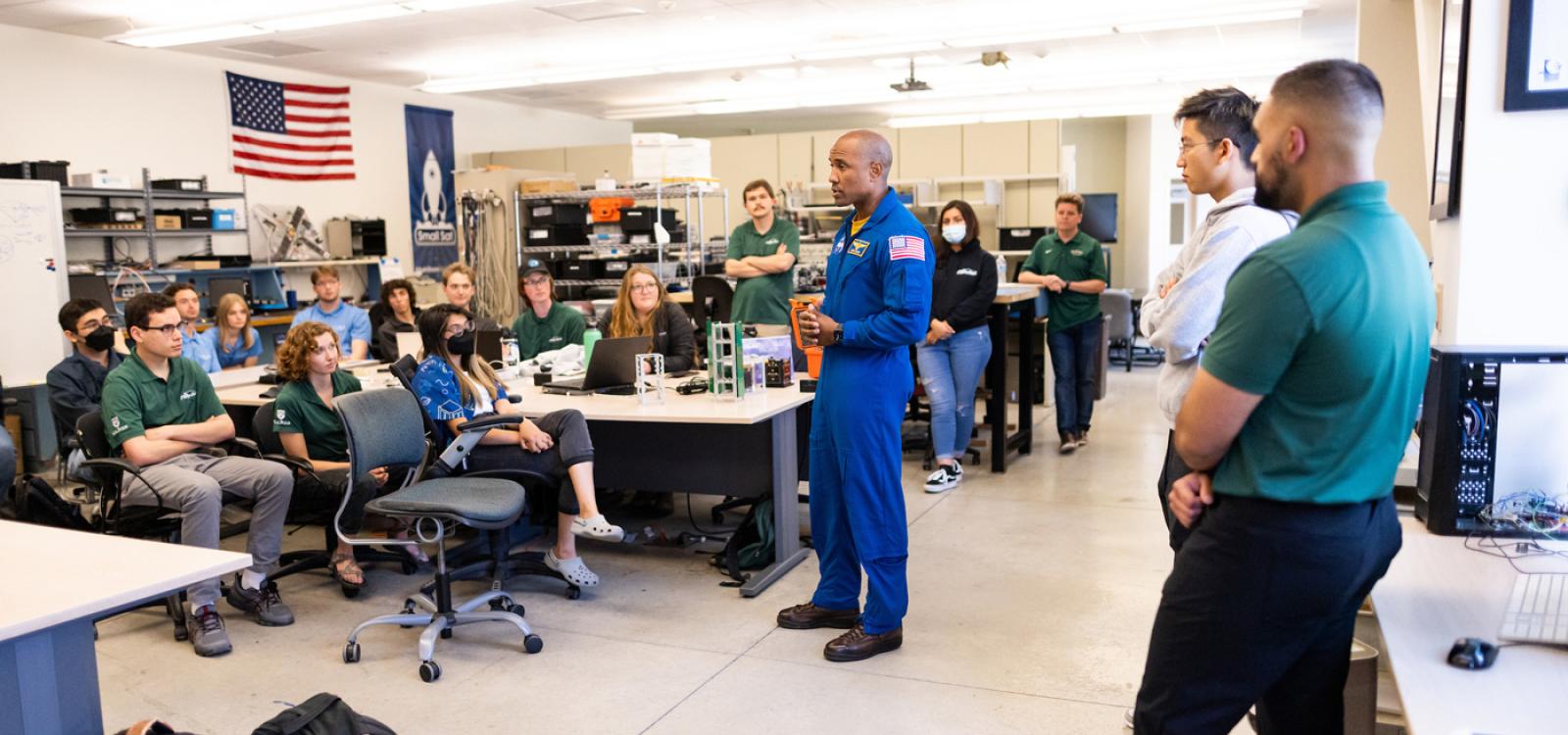 Inside the CubeSat lab, Captain Victor Glover talks to students about his experience on the International Space Station.