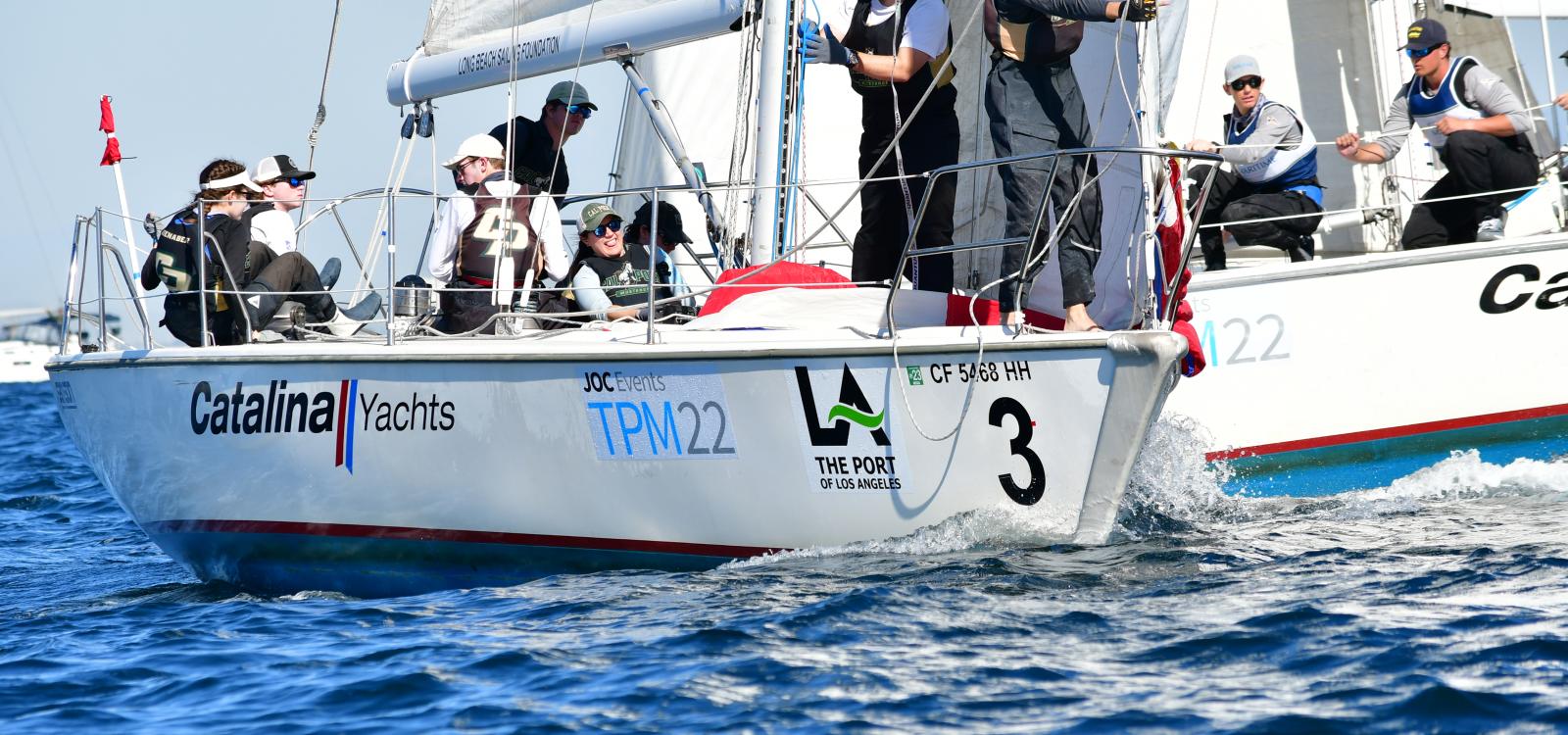 The Cal Poly Sailing Club works to sail their boat during a race. 