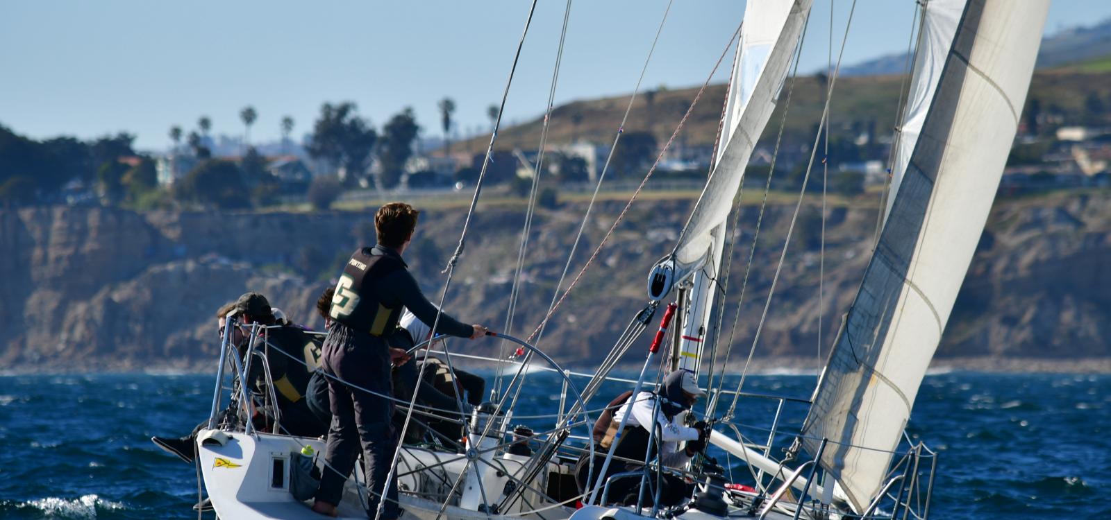 Kai Ponting, a member of the Cal Poly Sailing Club, drives the boat during the Los Angeles Harbor Cup. Ponting, a graduate student in aerospace engineering, plans to become a yacht designer and aerodynamicist. 