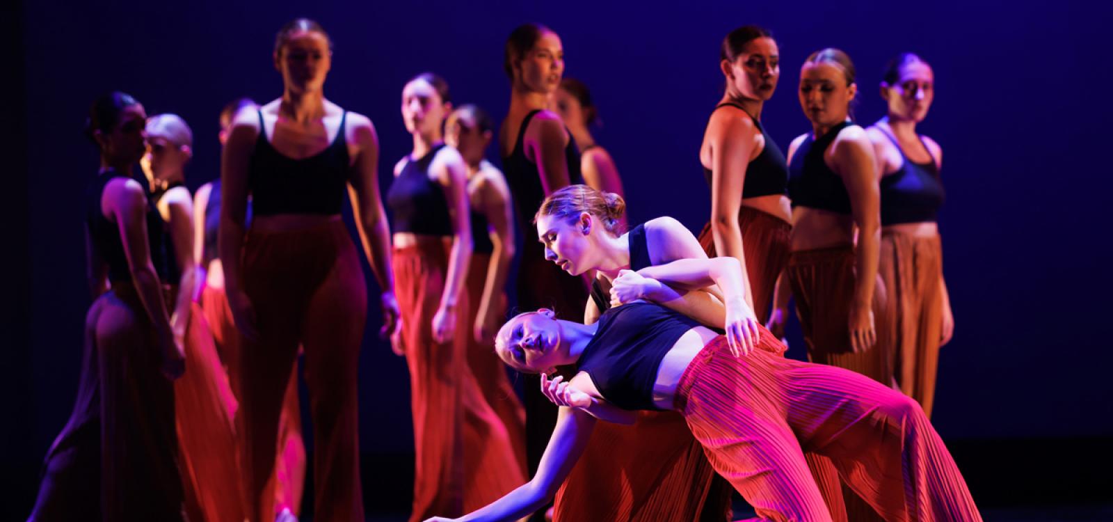 Dancers catch one another during the concert finale, "Before You Fall."