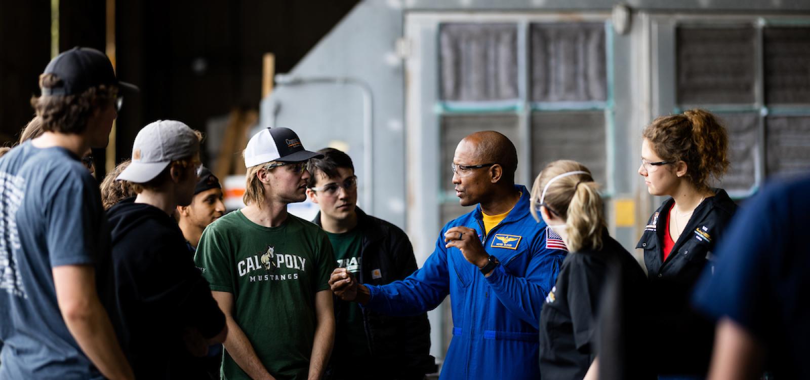 Victor Glover speaks to students as he takes a tour of the Cal Poly Aero Hanger Machine Shop during his visit to campus in April 2022.