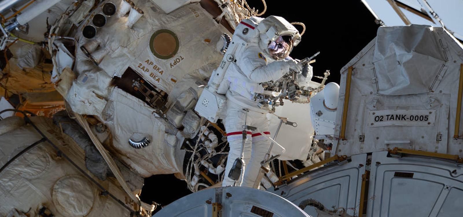 NASA astronaut and Expedition 64 Flight Engineer Victor Glover is pictured outside the Quest airlock during a 2021 spacewalk to service the station’s cooling system and communications gear with fellow NASA spacewalker Michael Hopkins (out of frame)