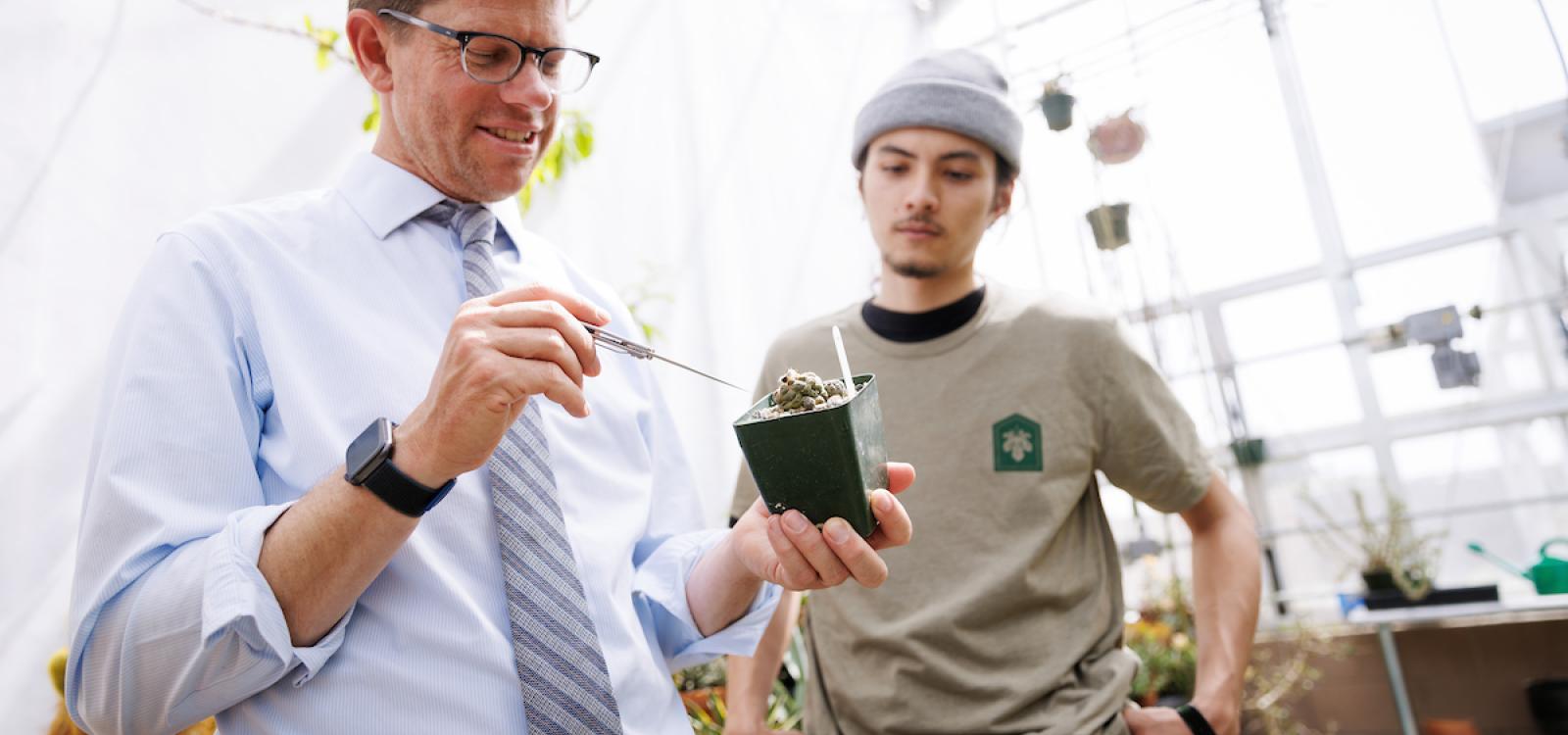 Professor Matt Ritter shows plant sciences student Jack McLure a small cactus.
