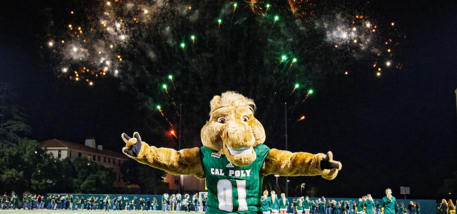 Musty poses with fireworks during the Big Fall Welcome at Spanos Stadium.