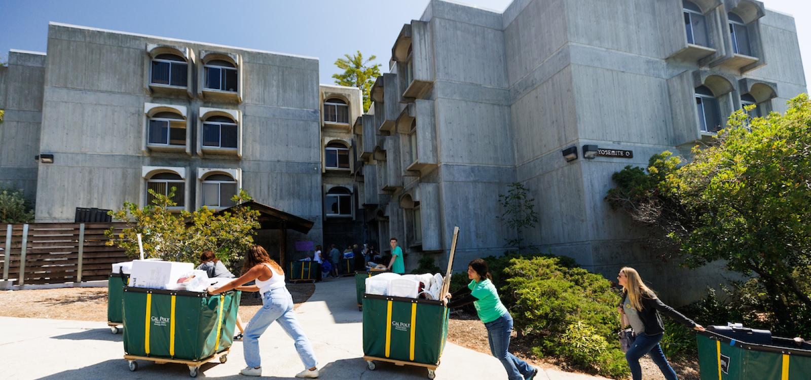 Students, family and friends participate in moving students into the dorms in September.