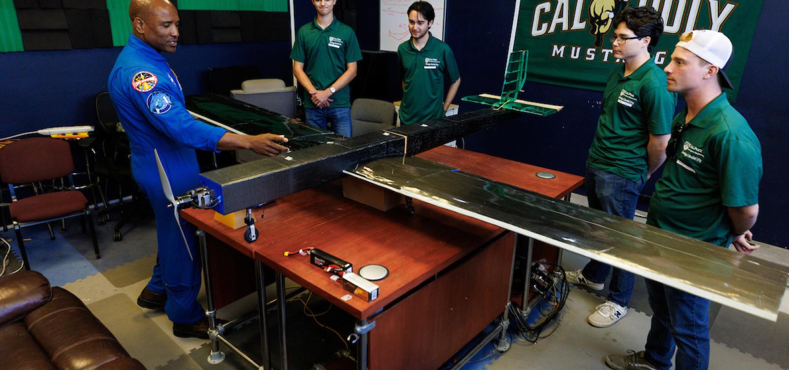 Glover speaks with students creating a remotely controlled autonomous research plane aiding Cal Poly’s Design Build Fly team in modeling flight dynamics.