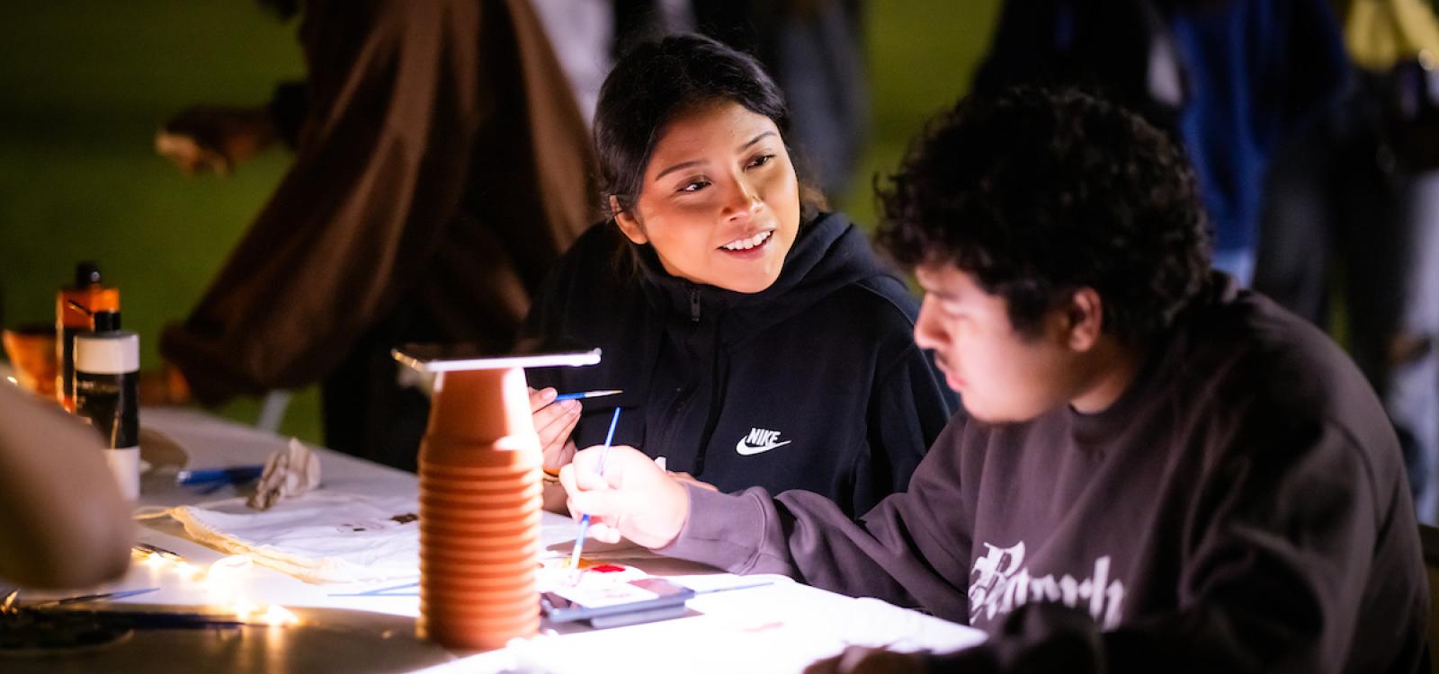 Students chat as they do arts and crafts at the WOW carnival.